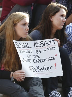 Roommates Megan Barnett of Wilmington and Laura Nagle of Hockessin take part during a rally in September 2014 to protest sexual harassment and assault at the University of Delaware.