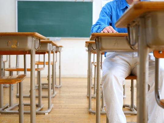 School classroom with school desks and blackboard