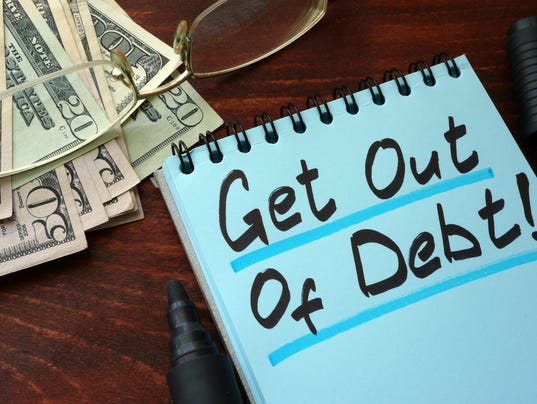 Get out of Debt written on a notepad with marker.