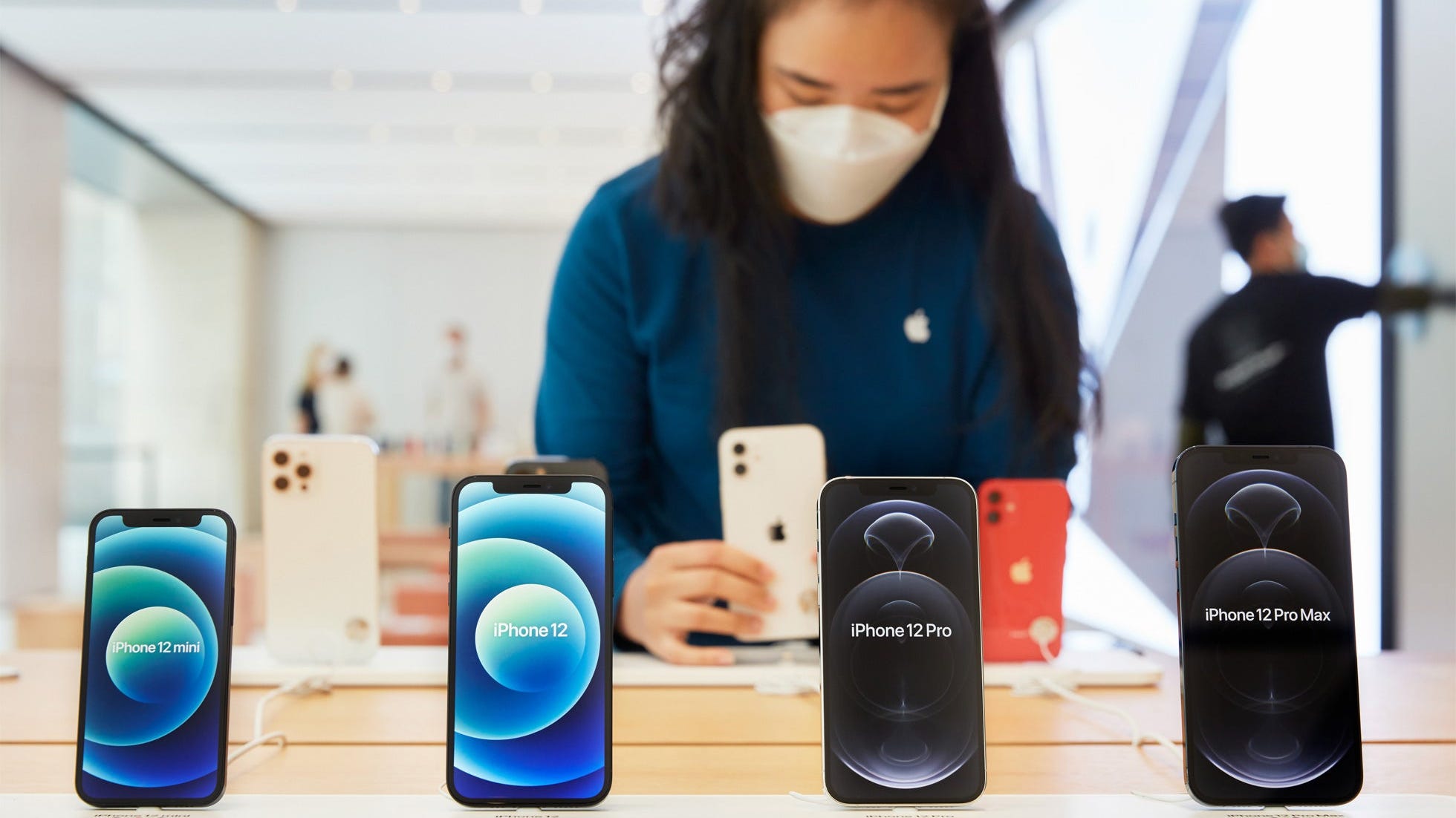 iPhone 12 devices in an Apple store.