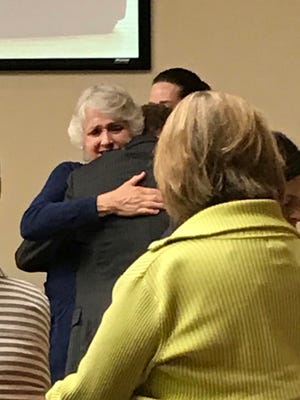 Raynella Dossett Leath is embraced in court Wednesday, May 10, 2017, after a special judge tossed out the first-degree murder case against her in the death of her second husband.