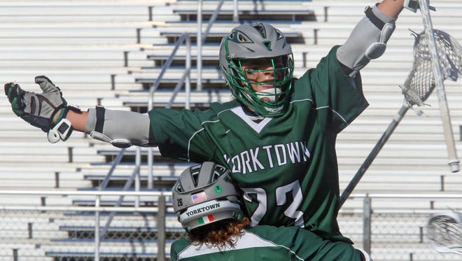 Yorktown's Dom Cioffi (26) celebrates with his teammate Hunter Embry (23) their 7-6 win over Shoreham- Wading River during boys lacrosse state semifinals at Hofstra University Shuart Stadium in Hempstead June 8, 2016. 