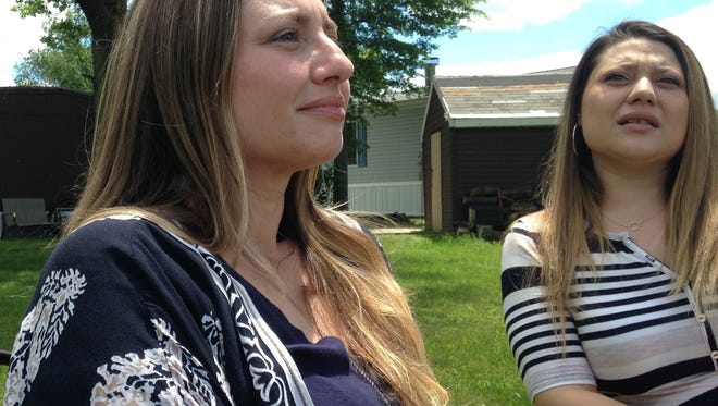 In this Wednesday, June 7, 2017 photo, Denyse DeLuca, left, and her sister, Stephanie, talk about their grandfather, Eugene, outside Denyse's home in Morrisville, Pa. Eugene DeLuca was shot and killed during a 1977 store robbery by 17-year-old Joseph Evans. In a March 2017 hearing to oppose Evan's release, Stephanie told the judge, "We never got the chance to call him Grandpop, feel his hugs, see his smile ... hear his laugh or hear him tell us he loves us. The defendant murdered our grandfather and stole all those opportunities from us all." (AP Photo/Mike Householder)