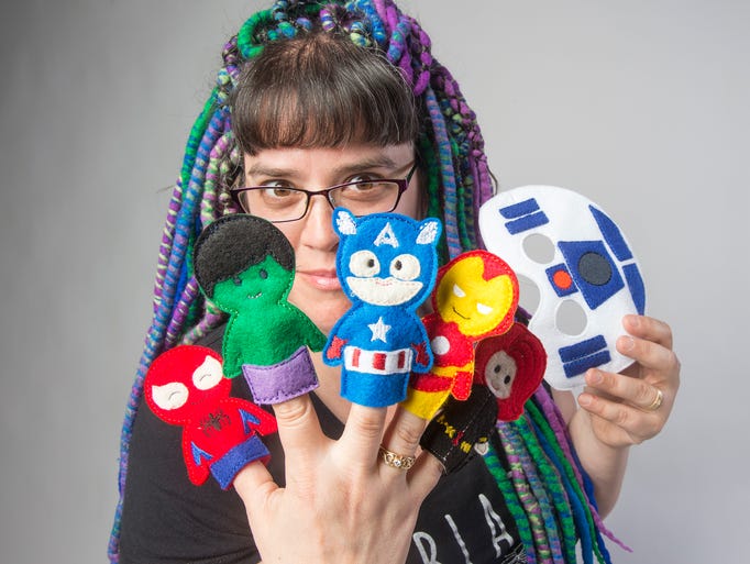 Emily Bowman with Tomboy Togs holds finger puppets