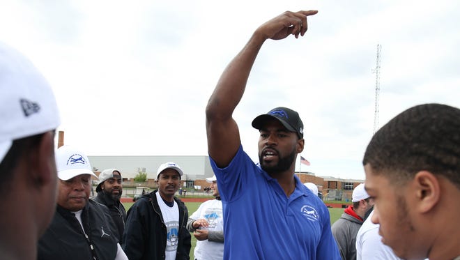 Former Lions receiver Calvin Johnson works with young players during the Calvin Johnson Jr. Foundation Catch a Dream football camp held at Southfield high school Saturday, May 20, 2017 in Southfield.