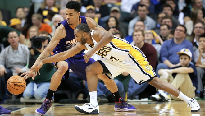 Pacers guard A.J. Price and Suns guard Gerald Green battle for a loose ball in the second half of the game at Bankers Life Fieldhouse on Saturday, Nov. 22, 2014. The Pacers lost to the Suns 106-83.