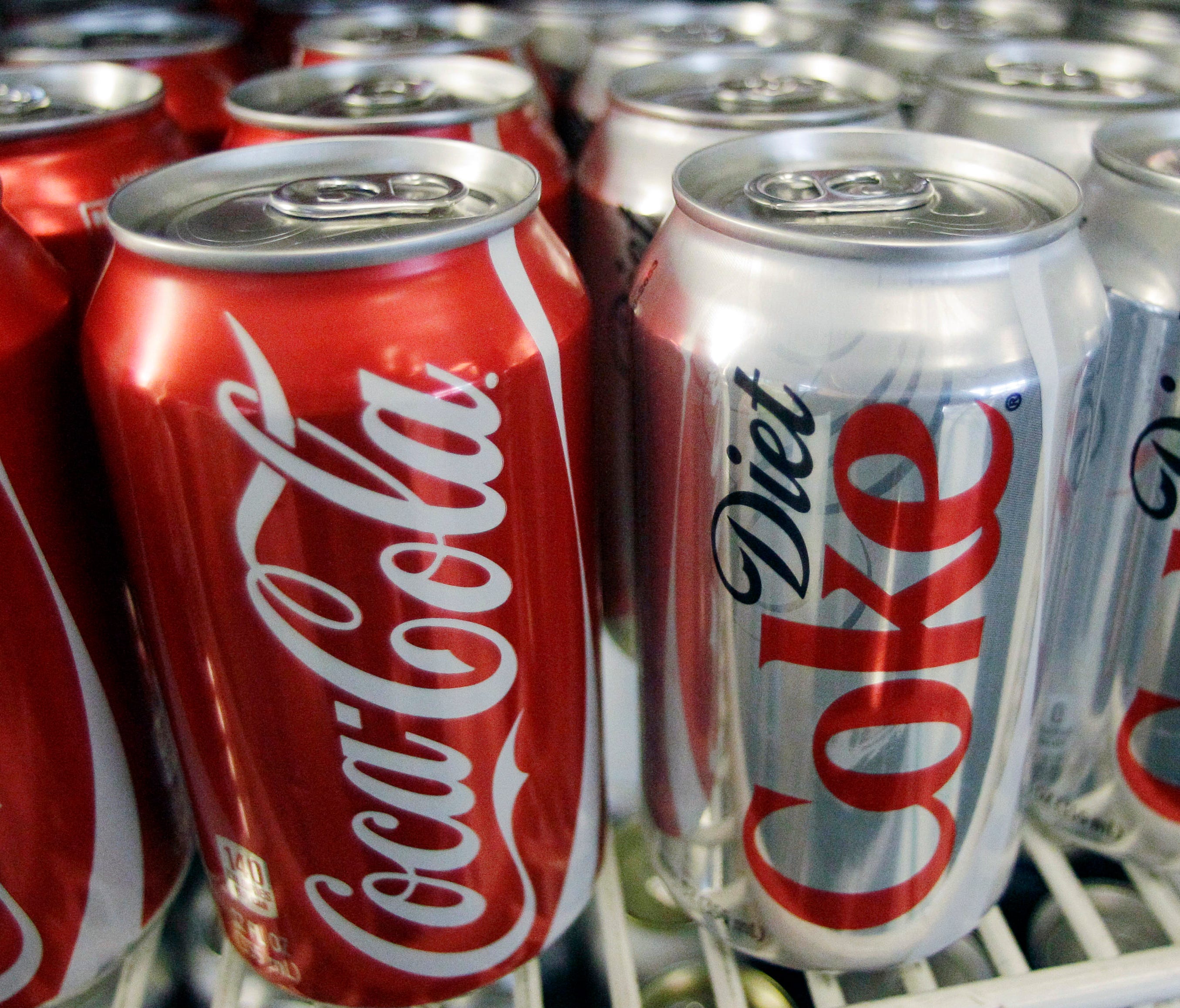 This file photo taken in 2011 shows cans of Coca-Cola and Diet Coke in a cooler at Anne's Deli in Portland, Ore.