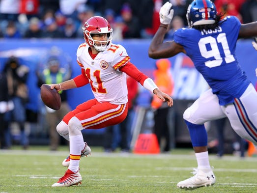 Kansas City Chiefs quarterback Alex Smith scrambles