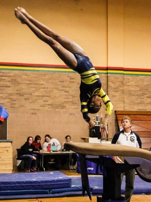 Grand Ledge sophomore gymnast  Janelle Hall competes on the vault during the Comets' match against St. Johns, Wednesday, January 7, 2015 at St. Johns.