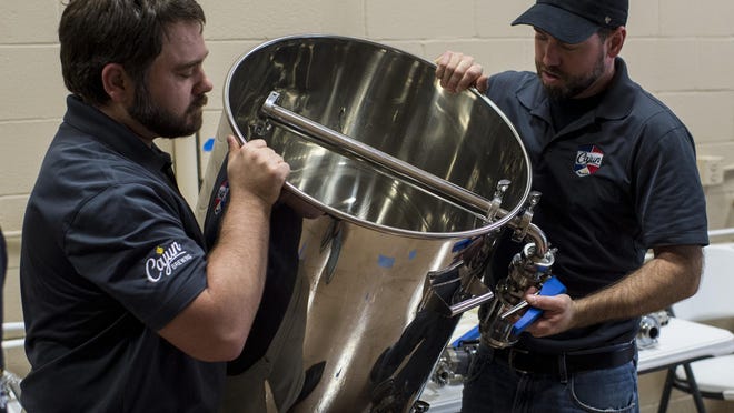 General manager Chad Lege and James Lutgring, head brewer and operations manager, explains the operations of a new mashtun used in the beer production process at Cajun Brewing in Lafayette, La., Tuesday, August 25, 2015.