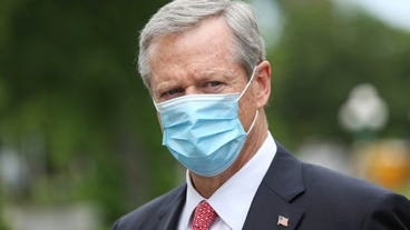 Gov. Baker wears he mask as he arrives at the Salvation Army in Boston last week.