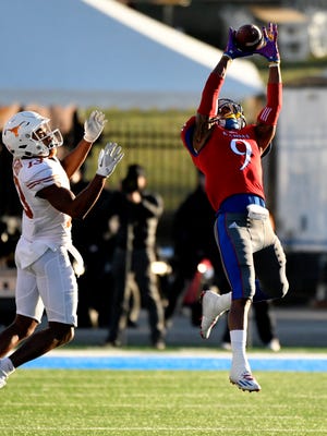 Fish Smithson #9 of the Kansas Jayhawks intercepts a ball intended for wide receiver Jerrod Heard #13 of the Texas Longhorns in the second quarter at Memorial Stadium.