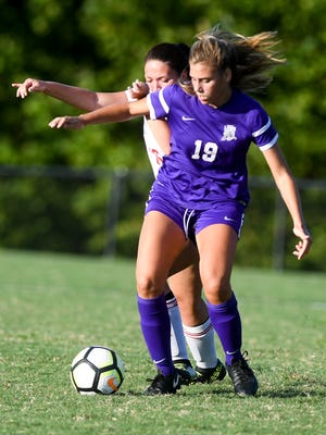 Lexington's Samantha Spain and Trinity's Ella Stone battle for possession of a loose ball during their game  Aug. 21. TCA won 2-0.