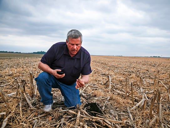 Secretary of Agriculture Bill Northey pulls up a soy