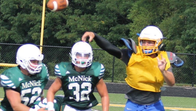 CNE quarterback Shawn Lykins throws on the run in a scrimmage against McNick prior to last season.