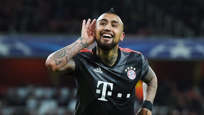 Bayern's Arturo Vidal celebrates after scoring their fourth goal during the UEFA Champions League Round of 16, second leg soccer match between Arsenal FC and Bayern Munich.