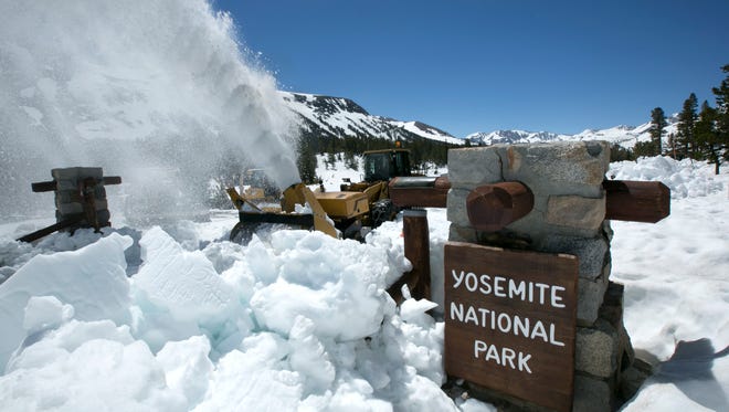 In this photo taken in June, a National Park Service snow blower clears the entrance to Yosemite National Park. This year's heavy snowfall had crews working to clear Highway 120 by summer.