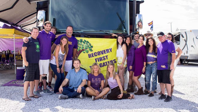 The current crop of Recovery First Tailgaters in front of their RV in its usual spot across from the LSU Veterinary Science building where they be welcoming folks to stop by prior to the Southern Mississippi game. Fourth from left is Dwayne Beason, founder of the Recovery First Tailgaters.  From left, including only first names is some cases, are Christopher Oshea, Chris Wrenn, Jacob, Dwayne Beason, MJ, Kevin Miner, Felicia Kleinpeter, Emily, Sarah, Linda, Charles, Alaina, Christopher Belleau, Courtney, Aaron Postil and  Amy.