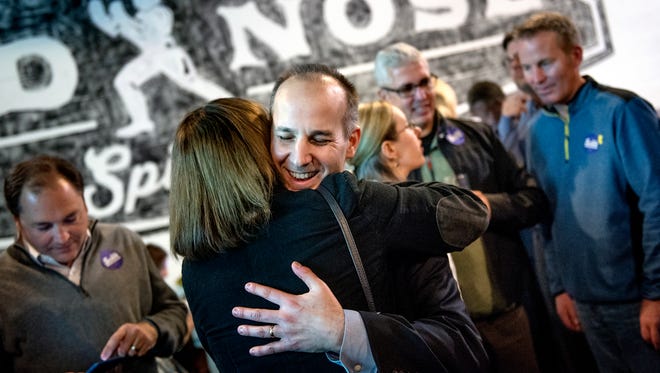 Lansing mayor candidate Andy Schor, right, hugs Elise Lancaster during Schor's election results watch party on Tuesday, November 7, 2017, at the Lansing Brewing Company.