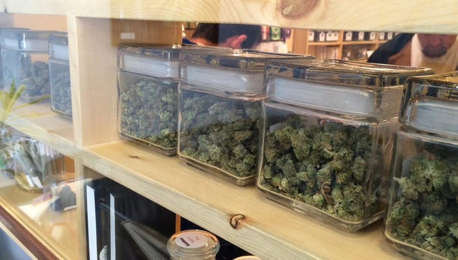 Jars of marijuana are stored in a Colorado dispensary. If Ohio passes the Marijuana Legalization Amendment, the state will issue licenses for 10 farms to grow the crop and for retail stories to sell marijuana and marijuana products.