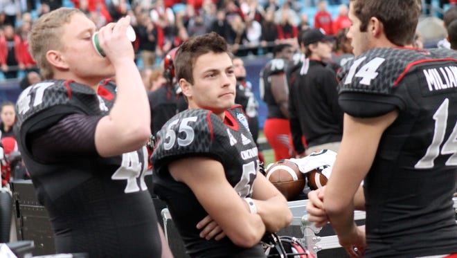 Tony Miliano (14) speaks with kicker Andrew Gantz (55) and long snapper Jon Vincent during the Belk Bowl in December.