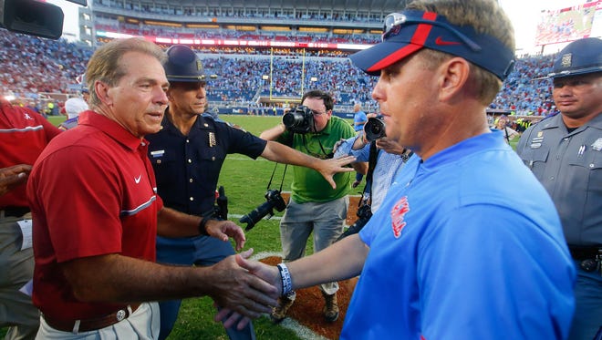 Head coach Hugh Freeze of the Mississippi Rebels congratulates head coach Nick Saban of the Alabama Crimson Tide after Alabama defeated Mississippi 48-43 at Vaught-Hemingway Stadium on Saturday in Oxford, Mississippi.