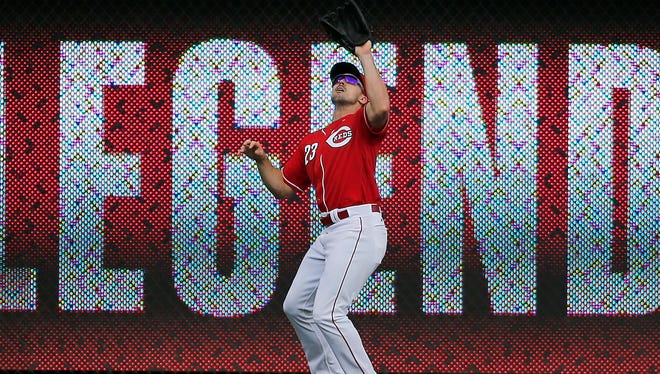 Cincinnati Reds left fielder Adam Duvall (23) makes a catch in deep left field off the bat of Chicago Cubs left fielder Jorge Soler (68) in the second inning of the MLB National League regular-season finale game between the Cincinnati Reds and the Chicago Cubs at Great American Ball Park in downtown Cincinnati on Sunday, Oct. 2, 2016.