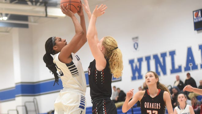 Zanesville's Tasia Staunton takes a shot against a New Philadelphia defender in Wednesday's ECOL game at Winland Memorial Gymnasium. The Quakers won 44-29.