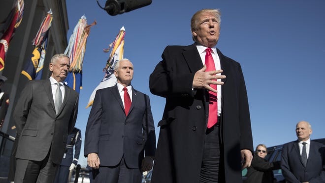 In this Jan. 18, 2018, file photo, President Donald Trump, joined by Defense Secretary Jim Mattis, left, Vice President Mike Pence, second from left, and White House Chief of Staff John Kelly, right, speaks to the media as he arrives at the Pentagon.
