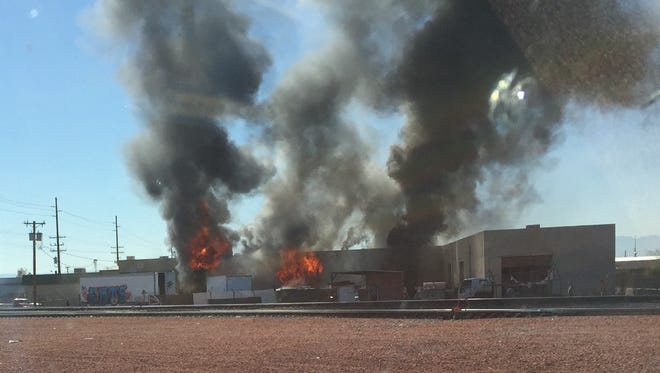 Black smoke and flames could be seen from Grand Avenue in Phoenix as a first-alarm fire broke out at a warehouse the morning of Feb. 25, 2017.
