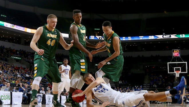 SIOUX FALLS, SD - MARCH 7:  North Dakota State players Dexter Werner #40, Carlin Dupree #3 and Khy Kabellis #13 and Joe Reed #44 of Fort Wayne scramble for a loose ball in the 2016 Summit League Tournament.     (Photo by Dave Eggen/Inertia)