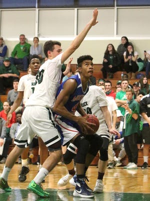 Senior Jonas Parker works in the paint during the Patriots' 62-47 loss to Rice in high school boys basketball Saturday.
