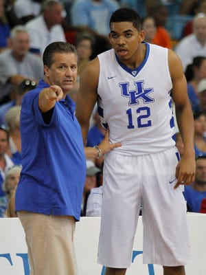 University of Kentucky freshman Karl-Anthony Towns gets some instructions from coach John Calipari during the Cats’ game against the Puerto Rico national team at the Big Blue Bahamas tour in Nassau, Bahamas, August 10, 2014.