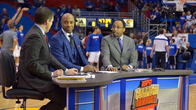 ESPN GameDay announcers Reece Davis (left), and Jay Williams (center), and Stephen A Smith broadcast from the court before the game between the Kansas Jayhawks and Texas Longhorns at Allen Fieldhouse.