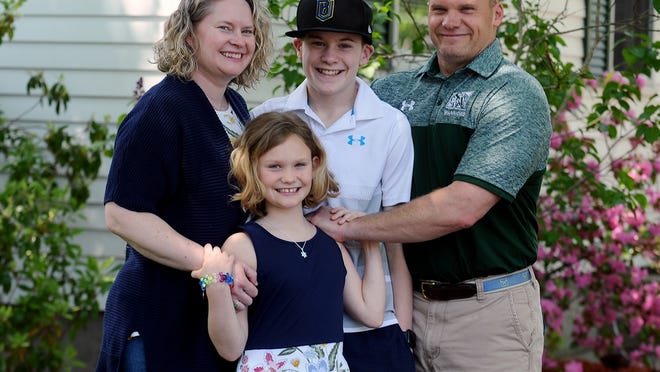 Nipmuc athletic director Chris Schmidt at his Franklin home with wife Amy, and kids Jaret, 14, and Callie, 10.