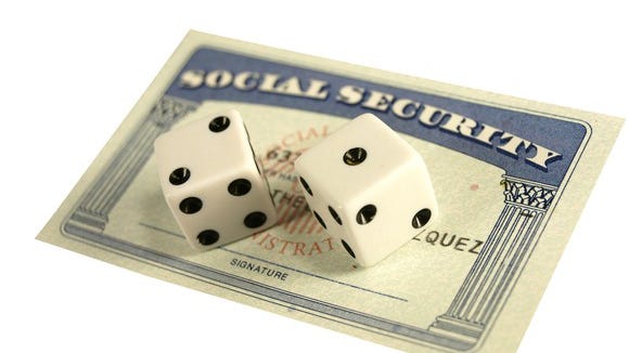 Social Security card with two dice on top of it.