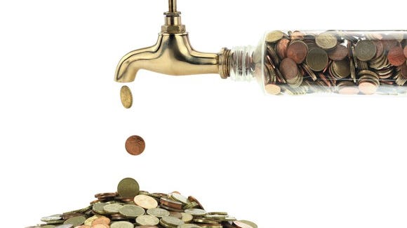 money pouring out of faucet