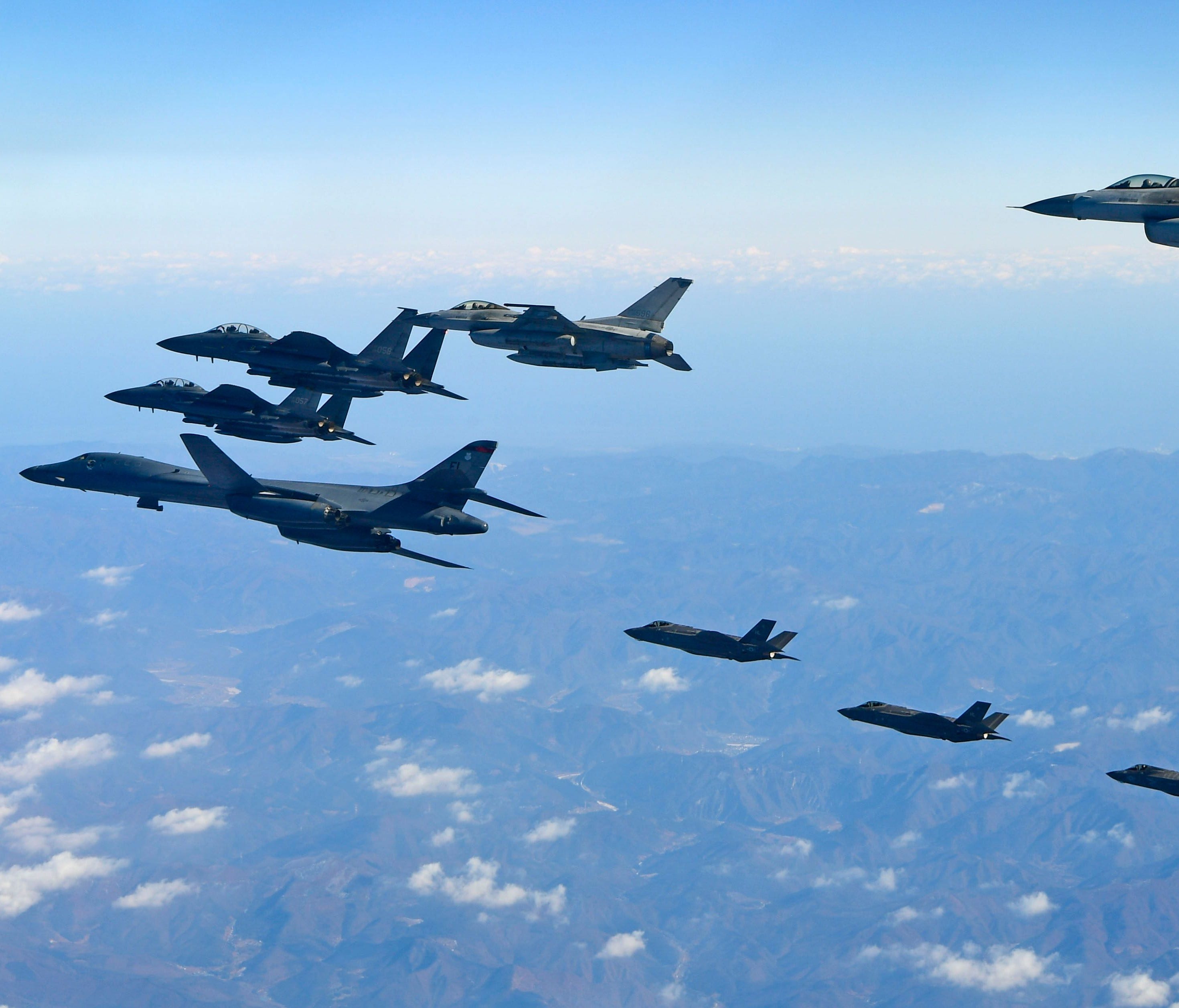 This handout taken and released by the South Korean Defence Ministry in Seoul on Dec. 6, 2017 shows a US Air Force B-1B Lancer bomber, two US F-35A and two US F-35B stealth jets flying over South Korea with South Korea's two F-16 and two F-15K fighte
