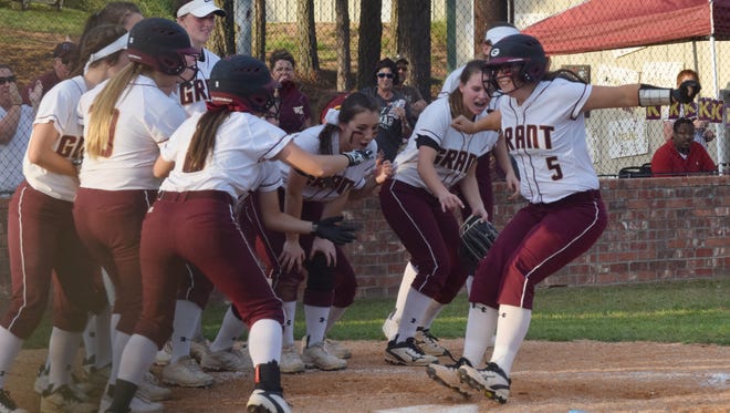Grant's Kelsey Mobley (5, right) prepares to jump on home plate after hitting a homerun against Breaux Bridge Friday.