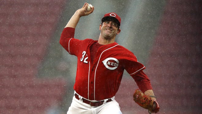 Matt Harvey throws a pitch as the rain intensifies in the sixth inning. A rain delay was the only thing that could stop the Reds starter as he threw 5 2/3 shutout innings against the Brewers, allowing just two hits while striking out six.