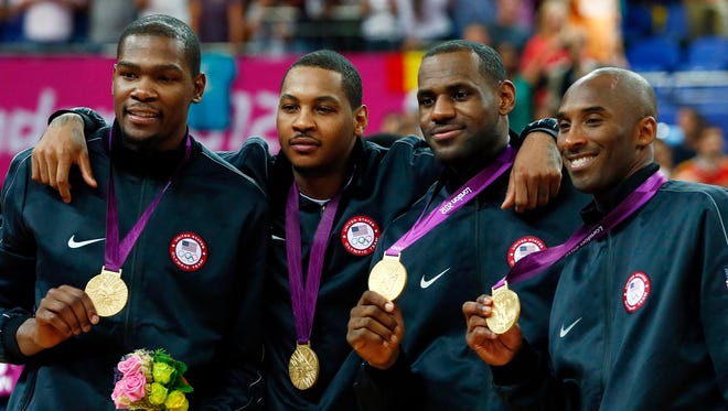 Kevin Durant, Carmelo Anthony, LeBron James and Kobe Bryant celebrate with their gold medals at the 2012 Olympics in London.