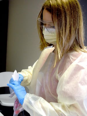 Kennedy Crigler, a laboratory associate at Boone Hospital Center, logs COVID-19 test specimens on Tuesday at the BHC drive-thru testing site. Boone Hospital has reported doing more than 1,000 tests this week, up from about 900 the previous week.