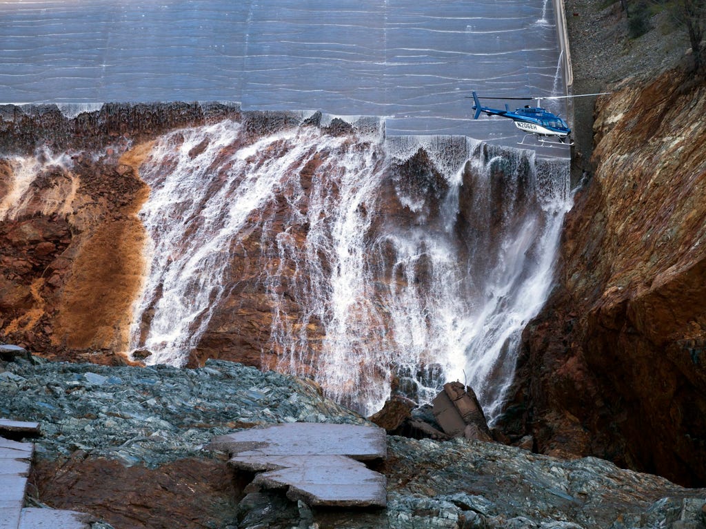 Oroville Dam's crippled spillway is inspected via helicopter after it was shut off, Feb. 27, 2017, in Oroville, Calif. California water authorities stopped the flow of water down the dam's spillway allowing workers to start clearing out massive debri
