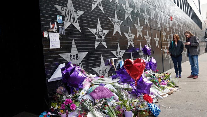 Fans visit the Prince star and memorial at First Avenue Friday, in Minneapolis where he often performed.