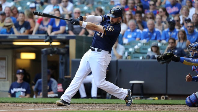 Travis Shaw follows through on his game-winning homer for the Brewers in the bottom of the 10th inning for the Brewers against the Cubs on Saturday at Miller Park.