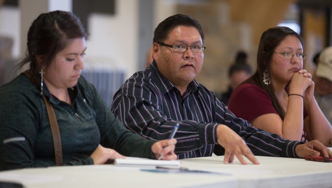 Navajo Nation Division of Community Development Executive Director Carl Smith answers questions Thursday during a meeting at the Nenahnezad Chapter house.