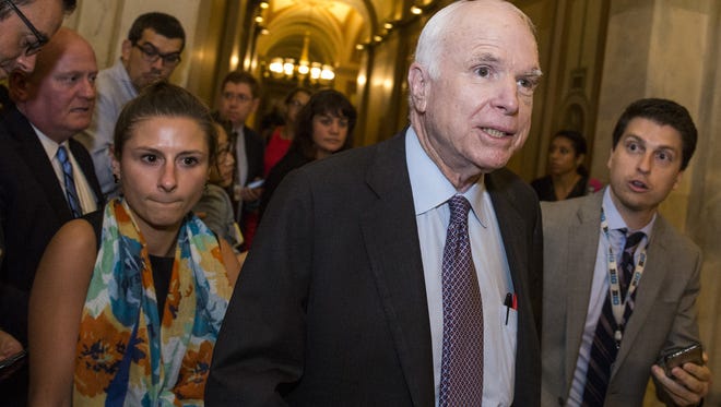 Sen. John McCain is pictured leaving the Senate Chamber after the Senate narrowly defeated a bill early Friday that would have repealed limited portions of the Affordable Care Act.