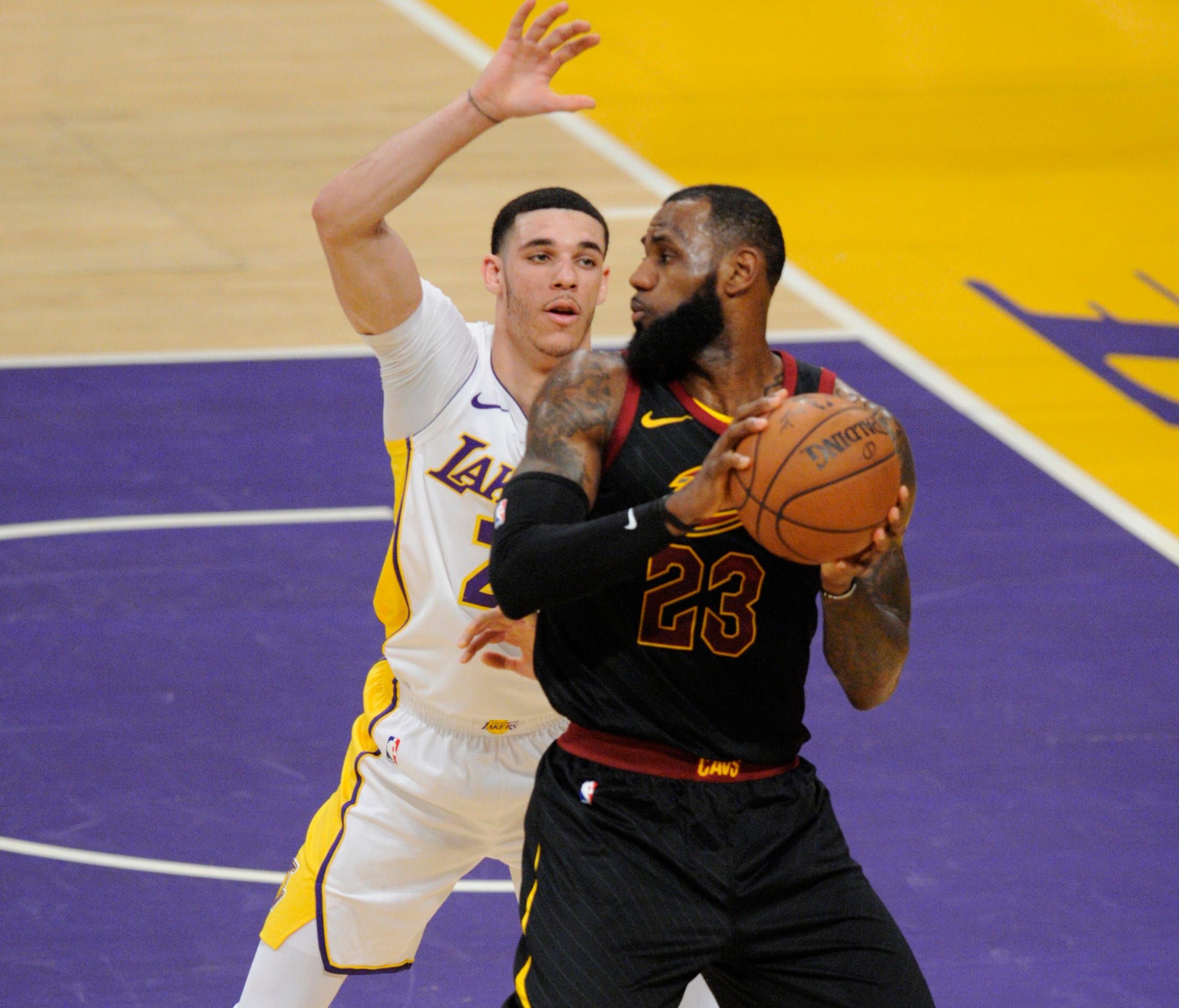March 11, 2018; Los Angeles, CA, USA; Cleveland Cavaliers forward LeBron James (23) moves the ball against Los Angeles Lakers guard Lonzo Ball (2) during the first half at Staples Center. Mandatory Credit: Gary A. Vasquez-USA TODAY Sports