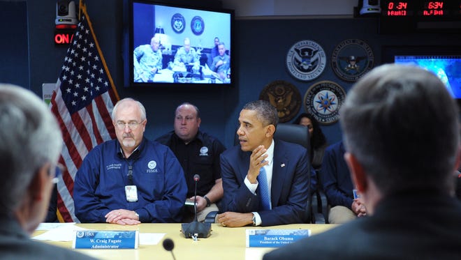President Barack Obama and Federal Emergency Management Agency Administrator Craig Fugate, left, take part in a meeting at FEMA headquarters on October 31, 2012 in Washington, D.C., to assess damage from Superstorm Sandy.