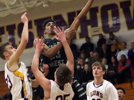 Wauwatosa West's Alou Dillon shoots over New Berlin